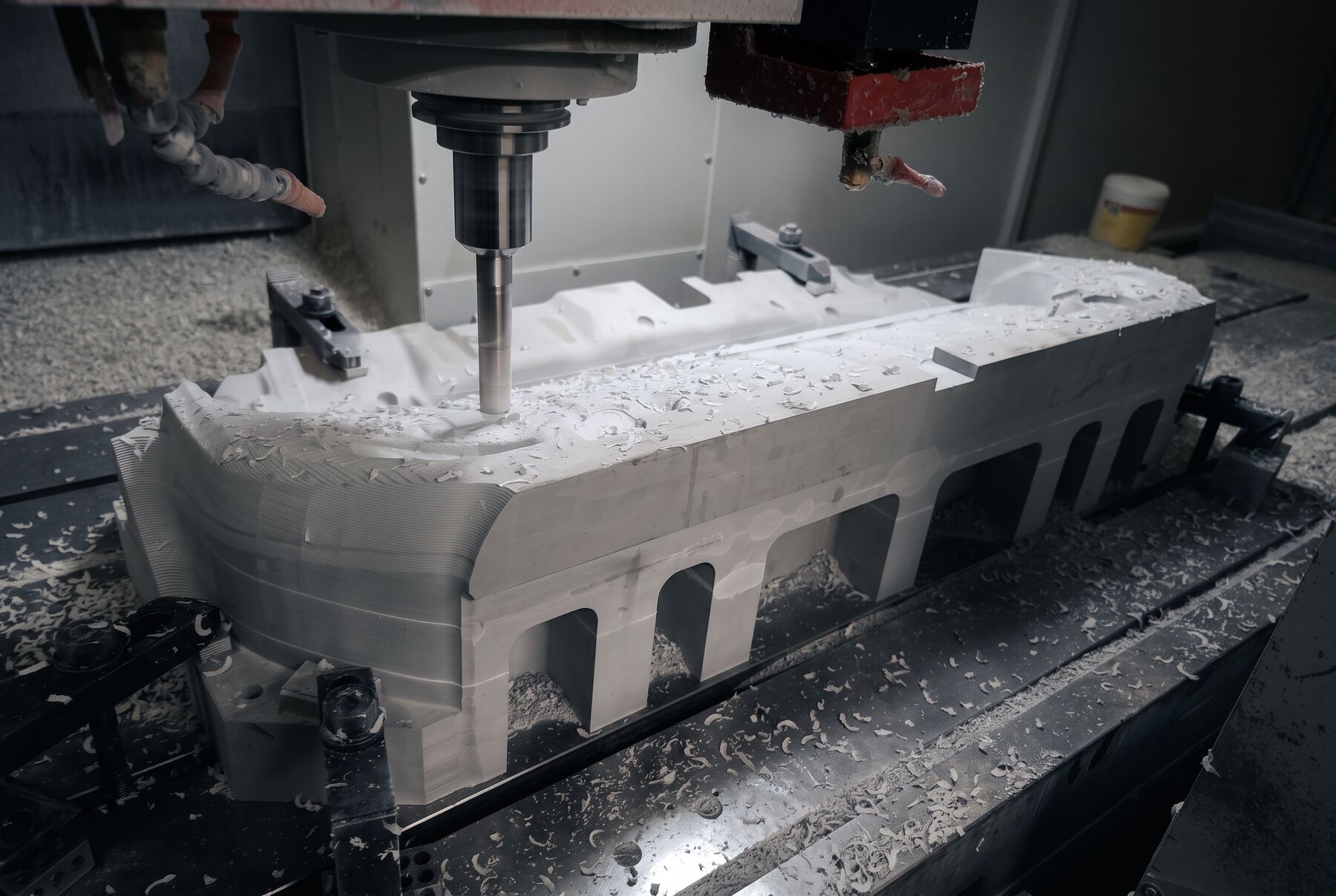 CNC machining centre milling a large aluminum part on the Guru Machines shop floor in Brampton, Ontario